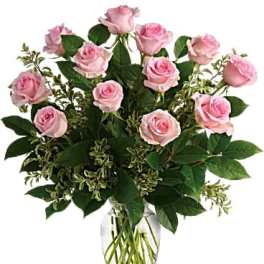 Pink roses arranged in a clear glass vase