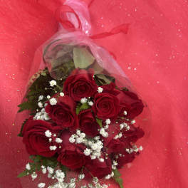 Bouquet of red roses with white baby's breath in clear wrap