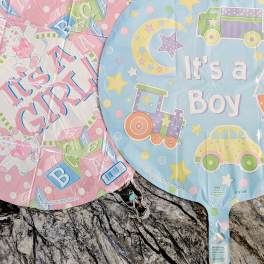 Three baby-themed foil balloons with dinosaur, girl, and boy designs