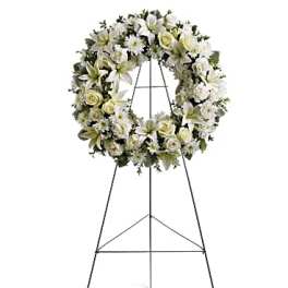 White floral wreath on a standing easel