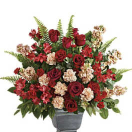 Red roses and carnations in a gray urn vase