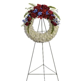 Standing funeral wreath with red and white flowers on an easel