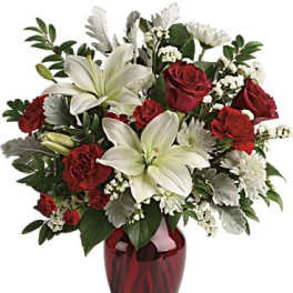 Red roses and white lilies arranged in a red vase