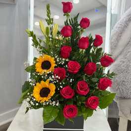Red roses and yellow sunflowers in a black box arrangement