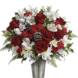 Red roses and white flowers in a silver vase