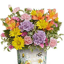Mixed bouquet of daisies, carnations, and roses in a painted glass vase