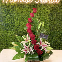 Red roses and pink lilies arranged in a basket