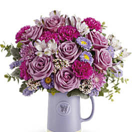 Lavender and pink bouquet in a purple mug vase