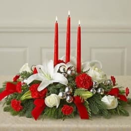 Red and white floral centerpiece with three red candles
