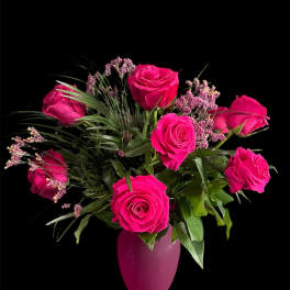 Hot pink roses arranged in a pink vase