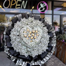 Large bouquet made of dollar bills with white filler flowers and gold chocolates