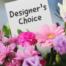 Mixed pink and white flower bouquet with a Designer's Choice sign