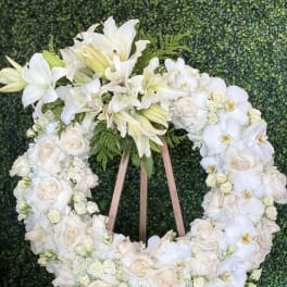 White floral wreath on a wooden easel