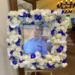 Large floral frame around a portrait on an easel