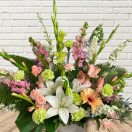 Mixed bouquet with white lilies, pink blooms, and green carnations