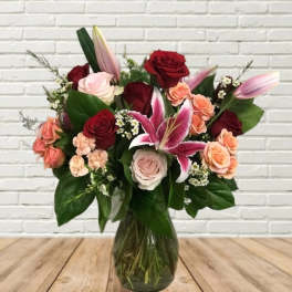 Mixed bouquet of roses and lilies in a glass vase
