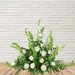 White rose arrangement with tall green spikes in a low design