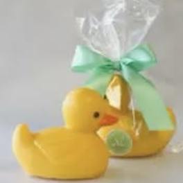 Yellow duck-shaped gift item wrapped in clear cellophane with a mint ribbon