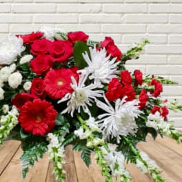 Red and white mixed flower arrangement with daisies and roses