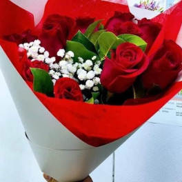 Bouquet of red roses with white baby's breath in red and white wrap