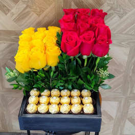 Yellow and red roses in a black box with gold chocolates
