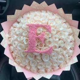 Large bouquet of white roses with a pink monogram topper