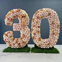 Two large floral number sculptures made of roses, shaped as 3 and 0.