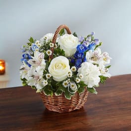 Basket of white roses and mixed blue-white flowers