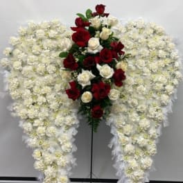 Standing floral spray with red and white roses surrounded by white flowers