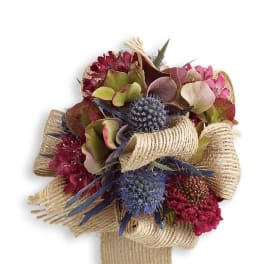 Bouquet of burgundy and pink flowers wrapped in burlap ribbon