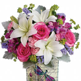 Pink roses and white lilies in a decorative glass vase