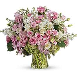 Pink and white rose bouquet in a clear glass vase