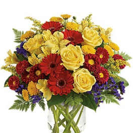 Bouquet of red and yellow flowers in a clear glass vase