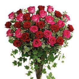 Bouquet of pink and red roses in a clear glass vase