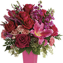 Pink and red rose bouquet in a tall pink vase