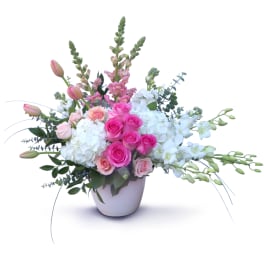 Pink and white floral arrangement in a white vase