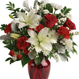 Red roses and white lilies arranged in a red vase