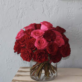 Bouquet of red and pink roses in a clear glass vase