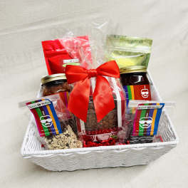 Gift basket with jars and snack packs tied with a red bow