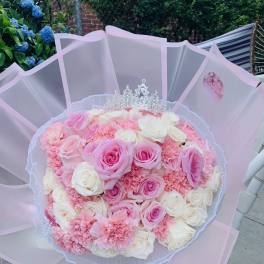 Pink and white rose bouquet with a silver tiara topper