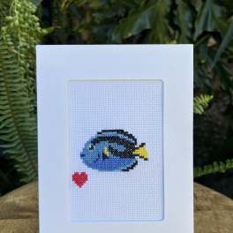White greeting card with a small cross-stitch fish and red heart