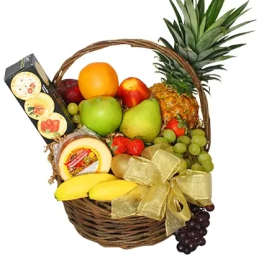 Fruit basket with pineapple, grapes, bananas, and packaged cheese