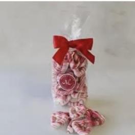 Clear bag of pink-and-white striped candies tied with a red bow