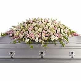Pastel floral spray on a silver casket
