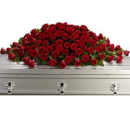 Red rose casket spray on a silver casket