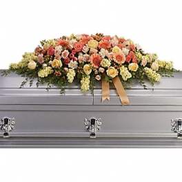 Large pastel floral casket spray on a gray casket