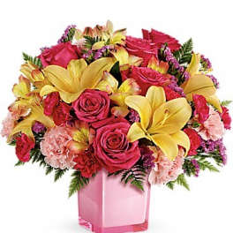 Pink roses and yellow lilies in a pink glass vase