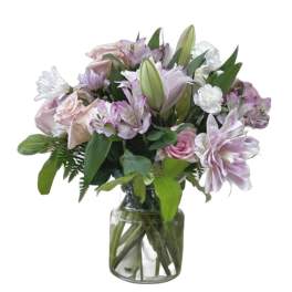 Mixed pink and white flowers arranged in a clear glass vase