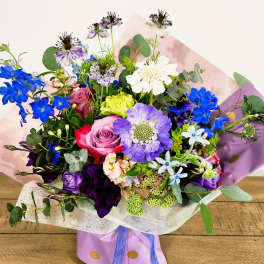 Bouquet of mixed flowers in purple and pink wrapping