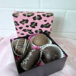Box of four assorted chocolate truffles in paper cups